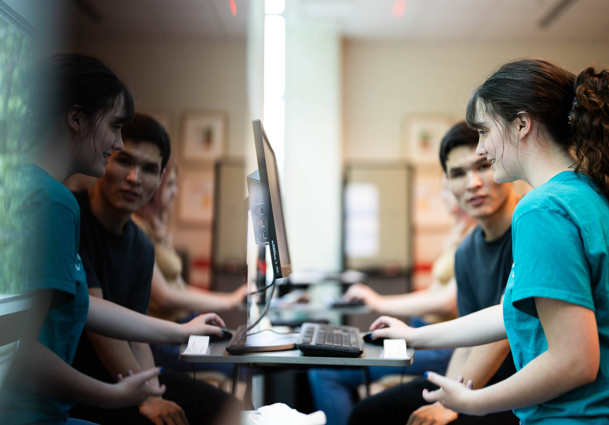 A consultant and a student working at a computer